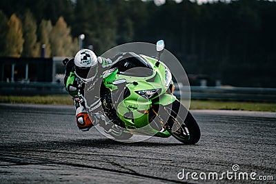 Man riding motorcycle in asphalt road. Motorcyclist at black and white sport motorcycle Editorial Stock Photo