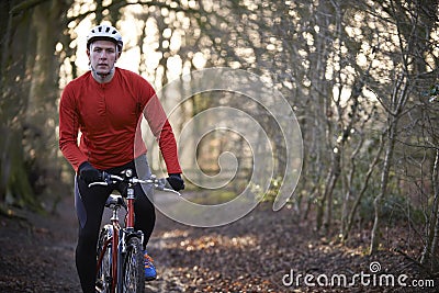 Man Riding Mountain Bike Through Woodlands Stock Photo