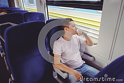 Man is riding a train, traveling by rail Stock Photo