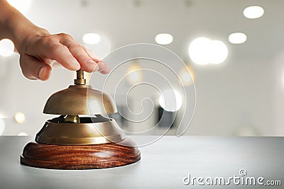 Man ringing hotel service bell on background, closeup. Space for text Stock Photo