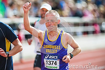 Man rising his hand on the final stretch at Stockholm Stadion Editorial Stock Photo