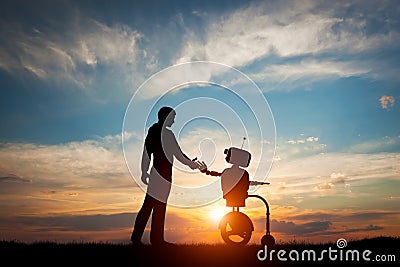 Man and robot meet and handshake. Concept of the future interaction with artificial intelligence Stock Photo