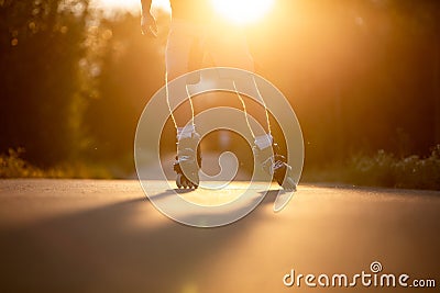 Man roller skating on the cycle path during lovely summer sunset, sport concept Stock Photo