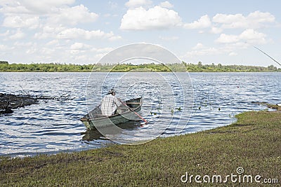 Man in a rowboat on the bank of the Rio Negro, in Mercedes, Uruguay Editorial Stock Photo