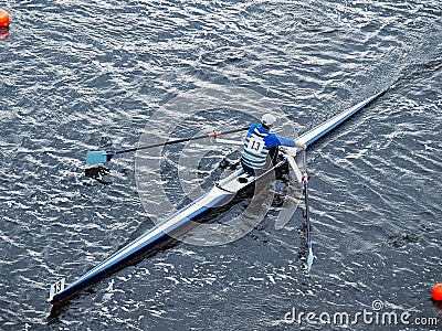 Man rowing in boat on water Stock Photo