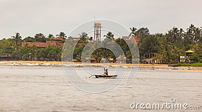 Man rowing an outrigger boat offshore Editorial Stock Photo