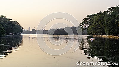 A man rowing in Rabindra Sarovar Lake in Minhaj Garden, Kolkata Editorial Stock Photo