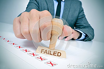Man with a rubber stamp with the word failed Stock Photo