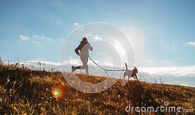 Man runing with his beagle dog at sunny morning. Healthy lifestyle and Canicross exercises jogging concept image Stock Photo