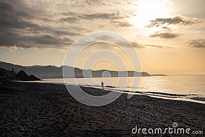 Early morning Run at Sunrise on the Beach Silhouette Stock Photo