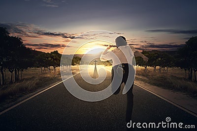 Man running chasing cross at the end of the road Stock Photo