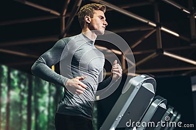Man running in a gym on a treadmill Stock Photo