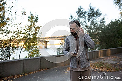 Man running in the morning listening music on phone. Stock Photo