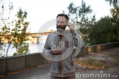 Man running and setting headphones. Stock Photo