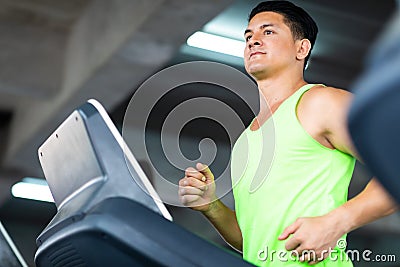 Man running on treadmill machine at gym sports club. Fitness Healthy lifestye and workout at gym concept Stock Photo