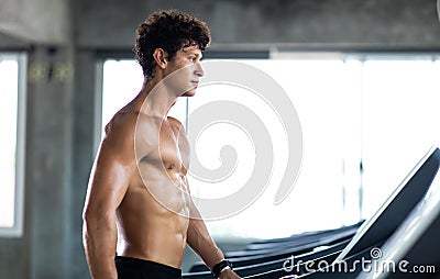 Man running on treadmill machine at gym sports club. Fitness Healthy lifestye and workout at gym concept Stock Photo