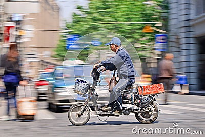 Man rushes on an electric bike, Shanghai, China Editorial Stock Photo