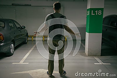 Man`s car was stolen, can`t find car at underground parking Stock Photo