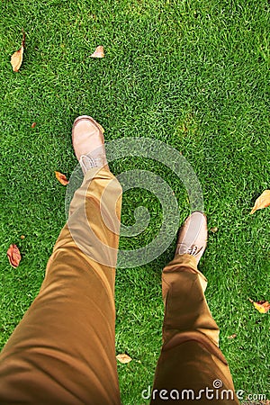 Man's feet in shoes on the grass. Stock Photo