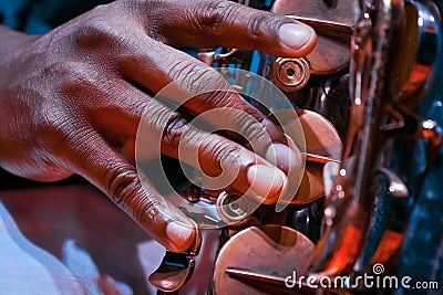 Man`s fingers press keys on his saxophone, playing live jazz, extreme closeup of a virtuoso`s hand Stock Photo