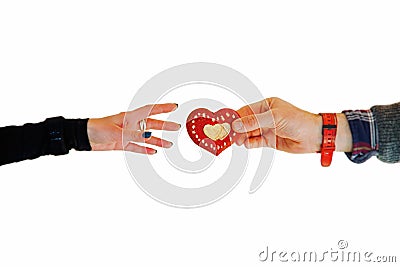 Man`s hand gives an heart to a woman`s hand. Love and charity concept Stock Photo