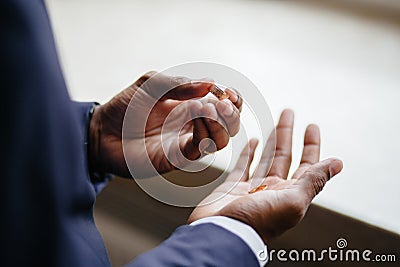 Man`s hand holding engagement rings Stock Photo