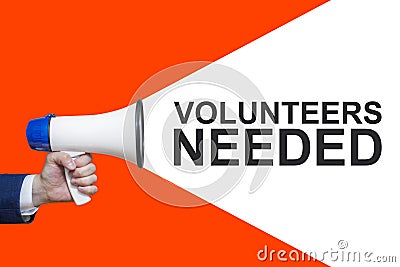 Man`s Hand Holding Megaphone With Speech Bubble VOLUNTEERS NEEDED. Announcement And Advertising Stock Photo