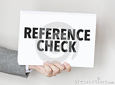 man's hand holding paper sheet with REFERENCE CHECKS words Stock Photo