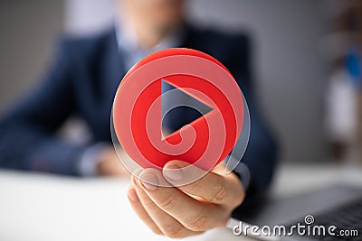 Man`s Hand Holding Play Icon Stock Photo