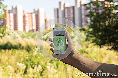 A man`s Hand holds a phone with the CovidSafe app Editorial Stock Photo