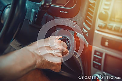 Man`s hand on ignition key about to start an suv Stock Photo