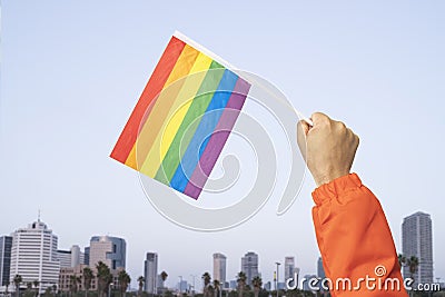 man\'s hand with LGBT flag at pride parade. fight for your rights Stock Photo