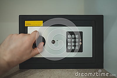 Opening small safe Stock Photo