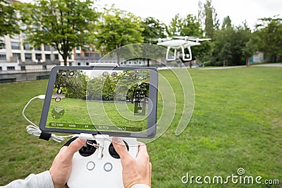 Man`s Hand Operating The Quadrocopter Stock Photo