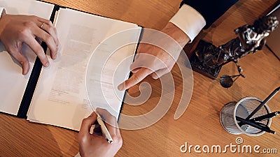 Man`s hand points with finger where to put signature on document. Signing contract on divorce. Stock Photo