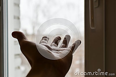 Man`s hand reaches for window. Concept: asking for help, depression, finding way out, freedom, sharing your feelings. Hand Stock Photo