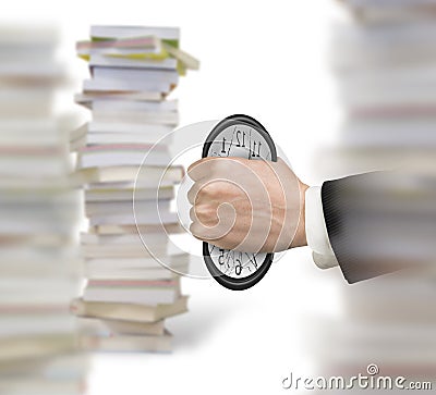 Man`s hand seizing clock to cause deformation with stacks books Stock Photo