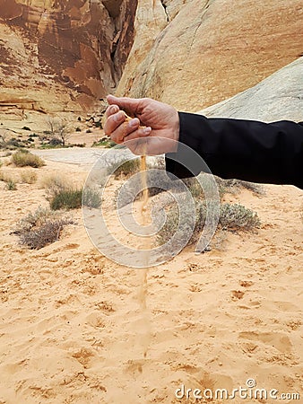 Man`s hand sifting sand in Valley of Fire State Park, Las Vegas, Nevada Stock Photo