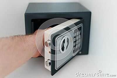 Man opening small safe Stock Photo