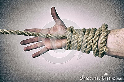 Man`s hand tied with a rope, vintage effect photo Stock Photo