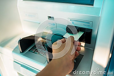 Man`s Hand Using Card To Withdraw Money Stock Photo