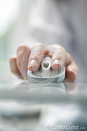 Man`s hand using cordless mouse on glass table. Stock Photo