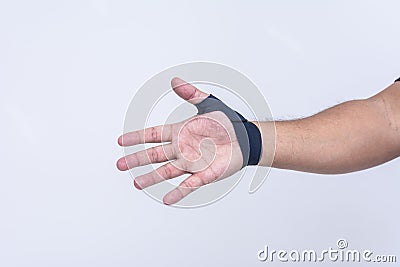 A man's hand wearing an ultra-thin compression wrist and thumb brace for texting thumb syndrome, carpal tunnel or tendonitis Stock Photo