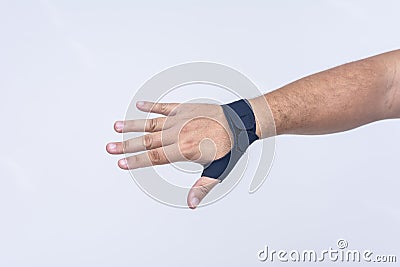 A man's hand wearing an ultra-thin compression wrist and thumb brace for texting thumb syndrome, carpal tunnel or tendonitis Stock Photo