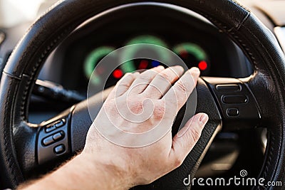 Man`s hand on the wheel of the car Stock Photo