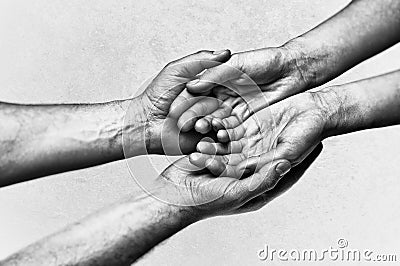 Man`s hands holding female palms on scratched background Stock Photo