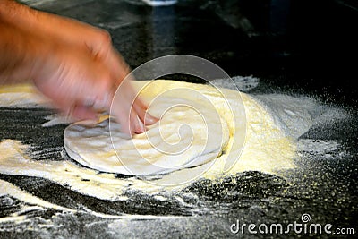 Man's hands kneading dough of pizza on the table Stock Photo