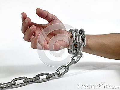 a man's hands shackled by chains Stock Photo