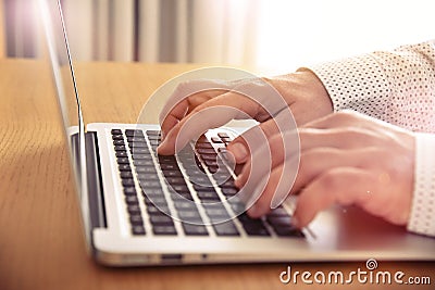 Man's hands typing on laptop keyboard. Stock Photo