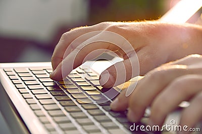 Man`s hands typing on laptop keyboard. Stock Photo